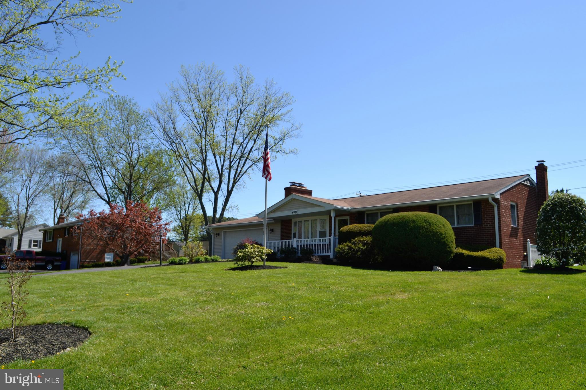 6421 Chell Road Columbia, MD 21044 - Photo 25 of 25 a front view of a house with a garden and trees