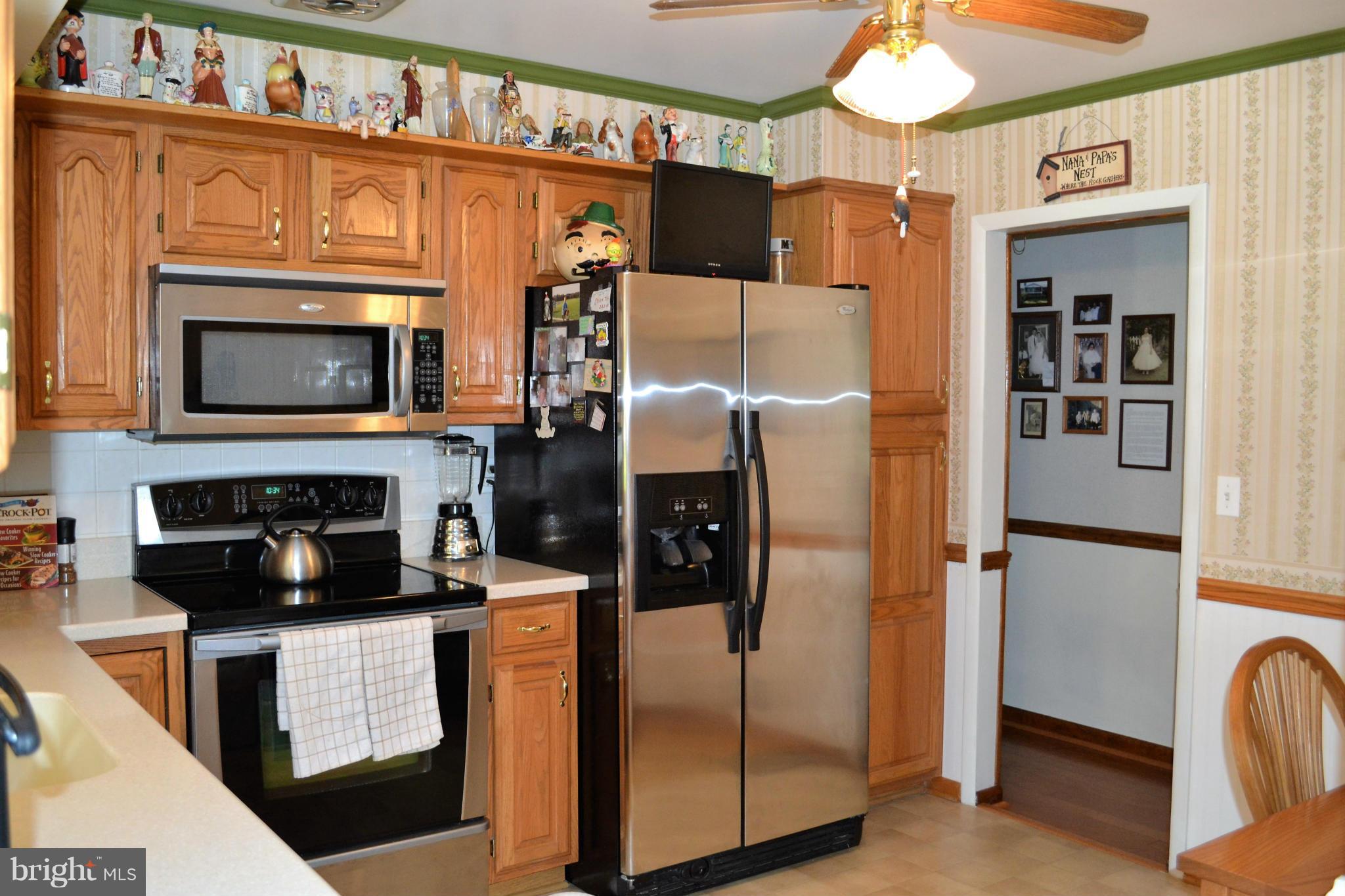 6421 Chell Road Columbia, MD 21044 - Photo 5 of 25 a kitchen with stainless steel appliances granite countertop a refrigerator a oven and a stove