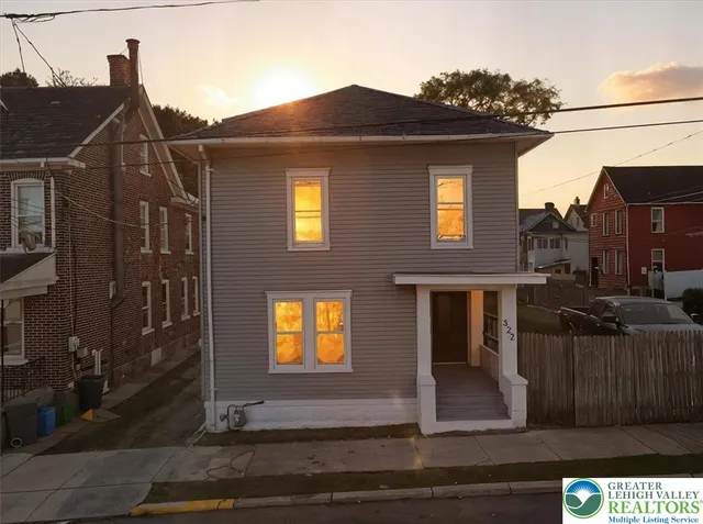 a view of a house with wooden fence