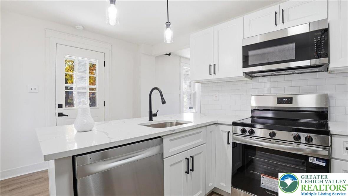 322 East Garrison Street Bethlehem, PA 18018 - Photo 7 of 24 a kitchen with stainless steel appliances a stove microwave and sink