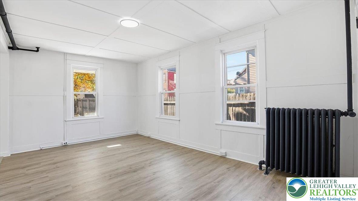 322 East Garrison Street Bethlehem, PA 18018 - Photo 8 of 24 an empty room with wooden floor and windows