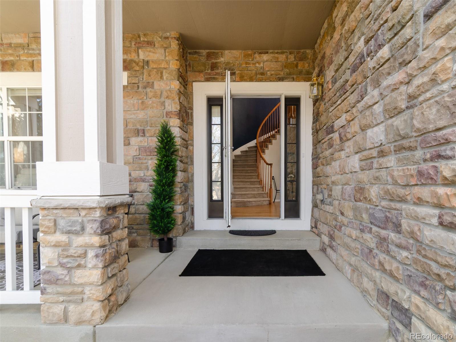 2080 Pearl Howlett Road Longmont, CO 80504 - Photo 13 of 46 a front view of a house with a yard