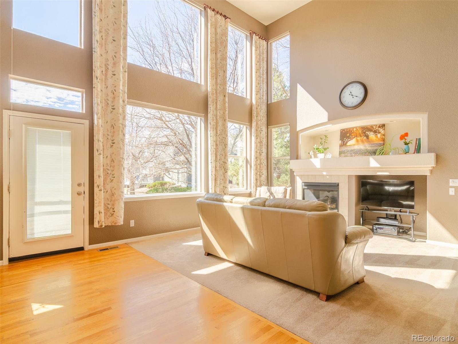 2080 Pearl Howlett Road Longmont, CO 80504 - Photo 16 of 46 a living room with a fireplace and a large window
