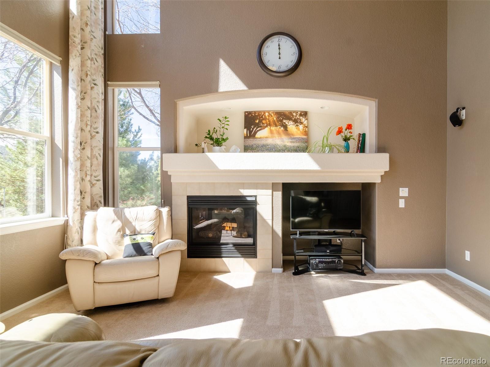 2080 Pearl Howlett Road Longmont, CO 80504 - Photo 17 of 46 a living room with furniture and a fireplace
