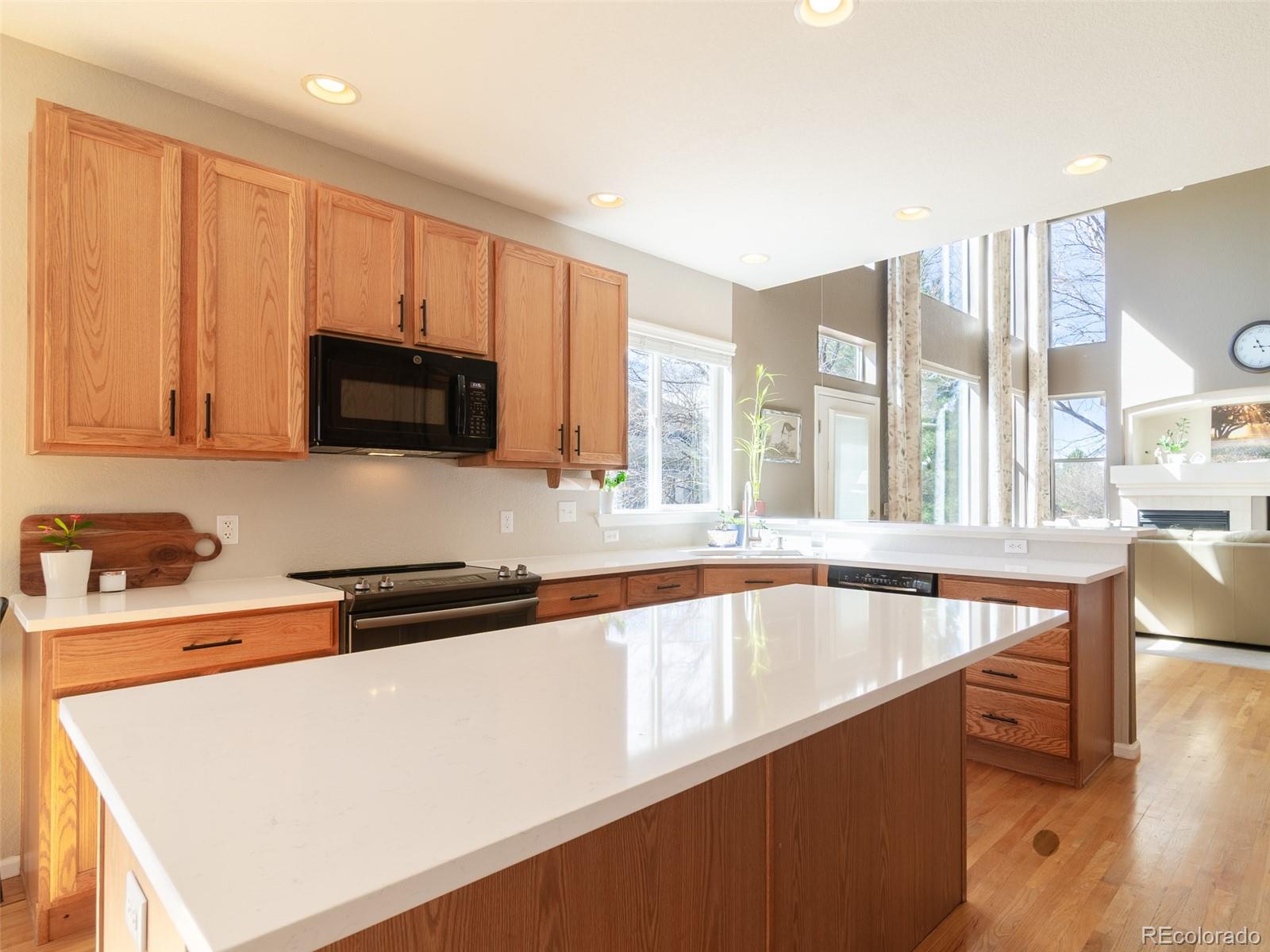2080 Pearl Howlett Road Longmont, CO 80504 - Photo 19 of 46 a kitchen with stainless steel appliances granite countertop a sink a stove and a microwave