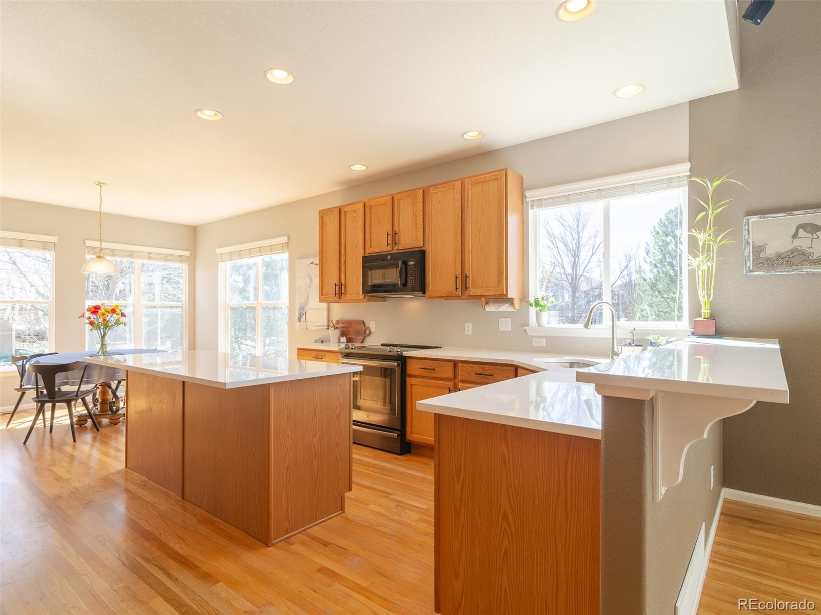 2080 Pearl Howlett Road Longmont, CO 80504 - Photo 20 of 46 a kitchen with stainless steel appliances granite countertop a stove and a refrigerator