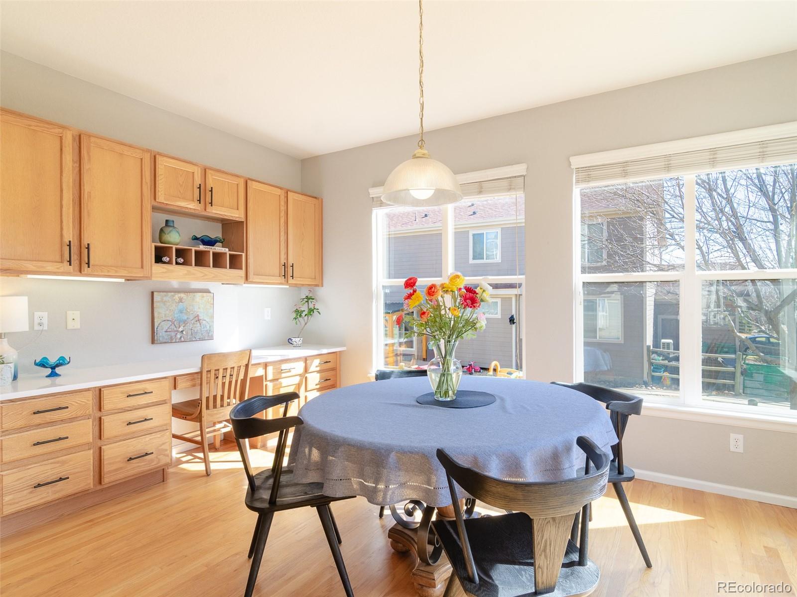 2080 Pearl Howlett Road Longmont, CO 80504 - Photo 22 of 46 a view of a dining room with furniture and a potted plant