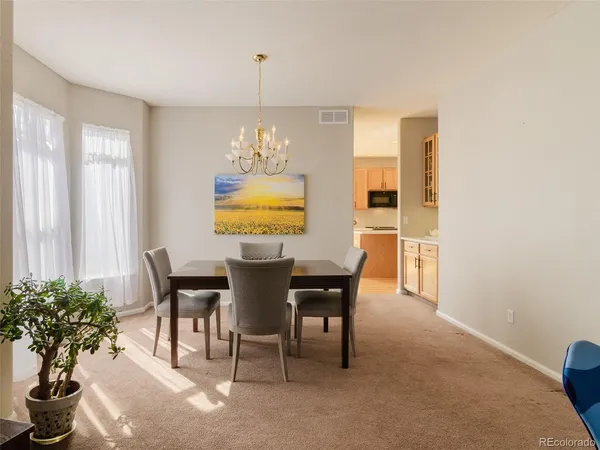 a view of a dining room with furniture and chandelier