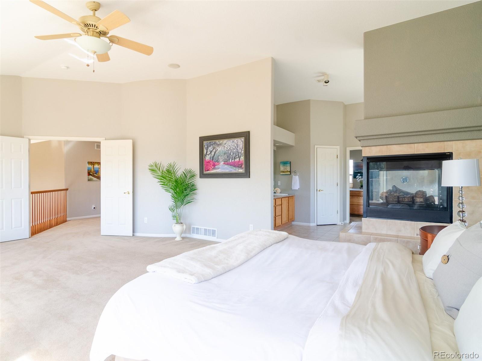 2080 Pearl Howlett Road Longmont, CO 80504 - Photo 33 of 46 a bedroom with a bed and a fireplace