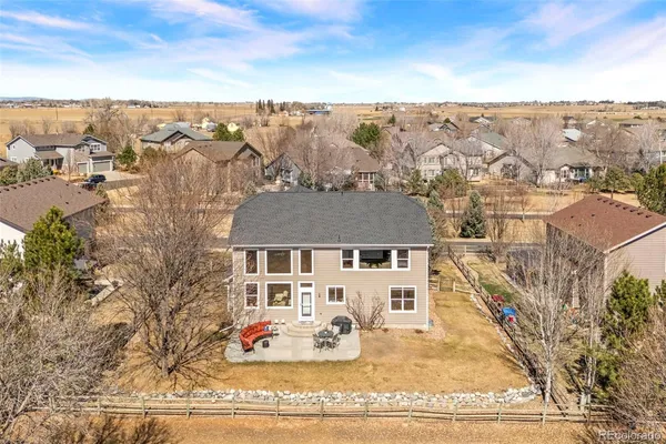 an aerial view of a house with a yard sitting area and garden
