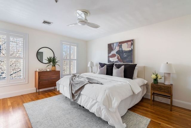 a bedroom with bed a table and chair