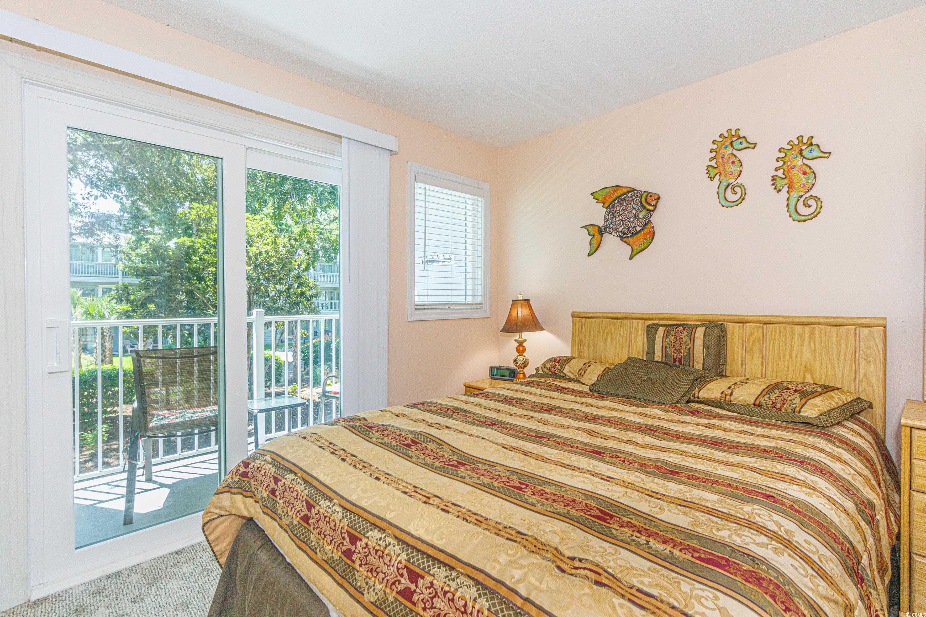 5905 South Kings Highway, Unit 4215 Myrtle Beach, SC 29575 - Photo 11 of 40 Carpeted bedroom with access to exterior