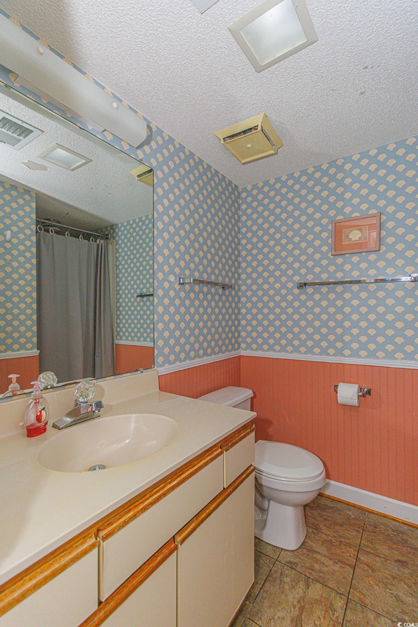 5905 South Kings Highway, Unit 4215 Myrtle Beach, SC 29575 - Photo 17 of 40 Full bath featuring a wainscoted wall, vanity, wallpapered walls, a textured ceiling, and wood walls