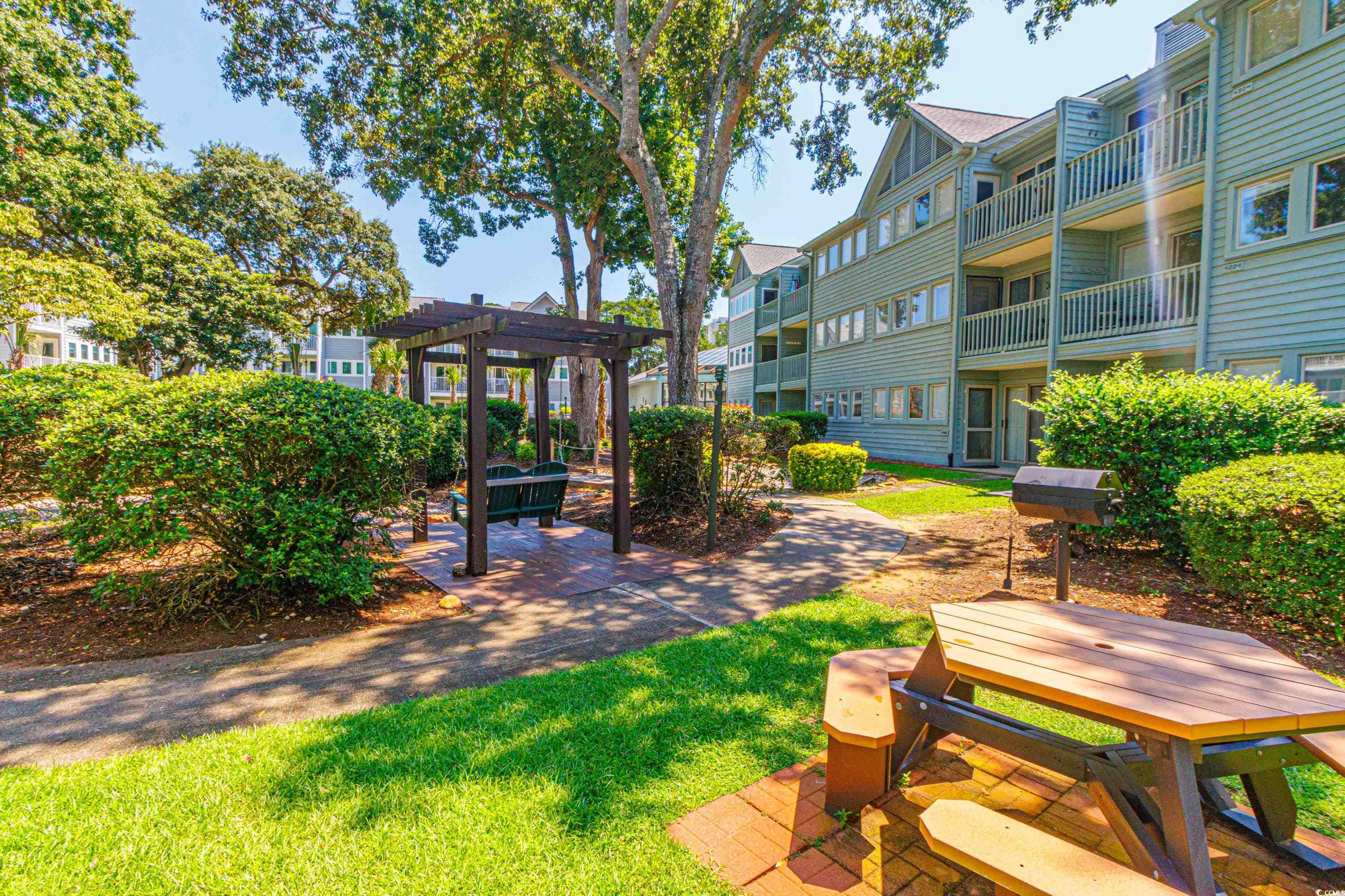 5905 South Kings Highway, Unit 4215 Myrtle Beach, SC 29575 - Photo 21 of 40 View of grassy yard with a patio and a pergola