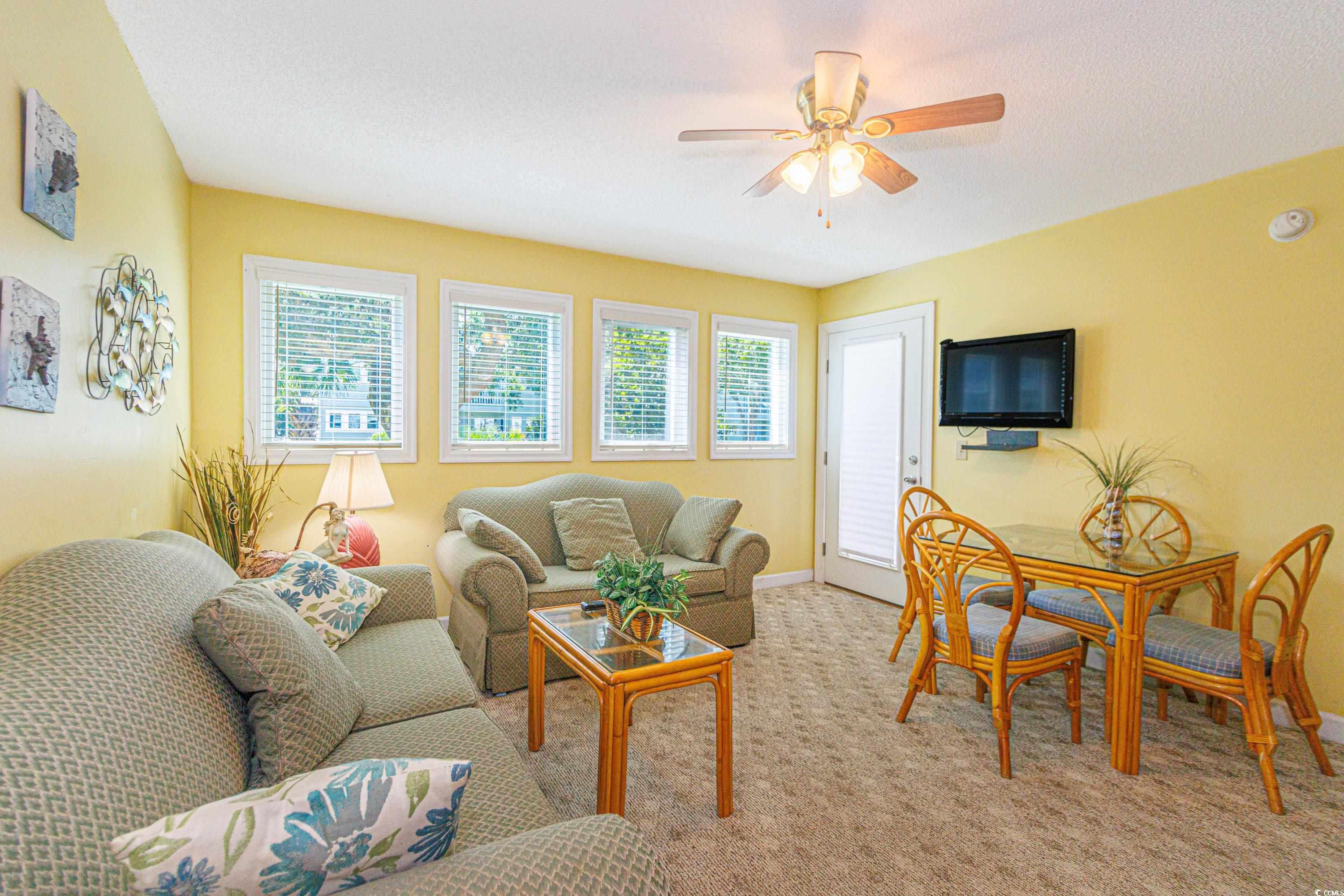 5905 South Kings Highway, Unit 4215 Myrtle Beach, SC 29575 - Photo 4 of 40 Carpeted living room featuring baseboards and ceiling fan