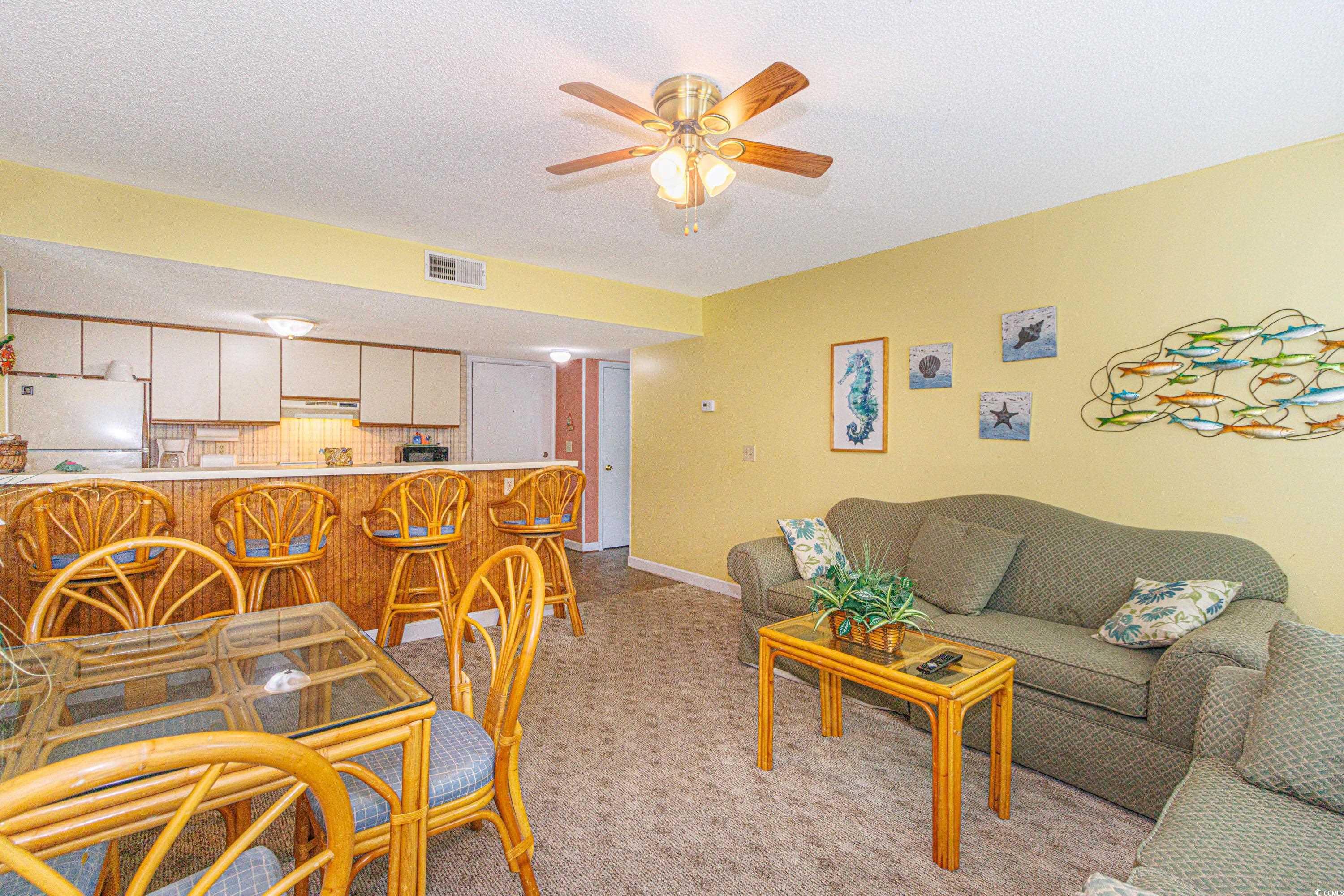 5905 South Kings Highway, Unit 4215 Myrtle Beach, SC 29575 - Photo 6 of 40 Living room featuring a textured ceiling, light carpet, and a ceiling fan