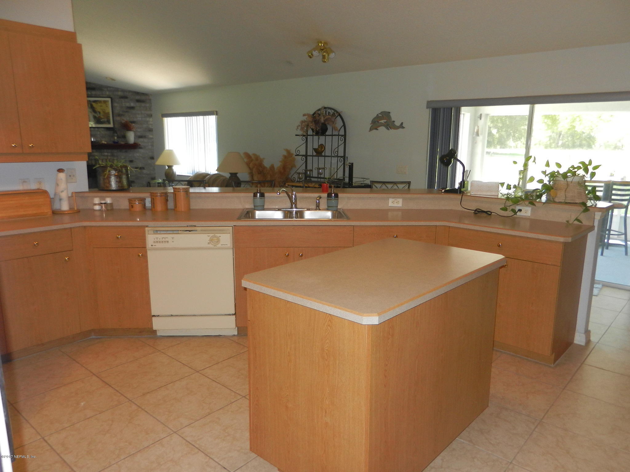 2205 Brownlee Road Seville, FL 32190 - Photo 11 of 27 a kitchen with a sink a counter top space and a window