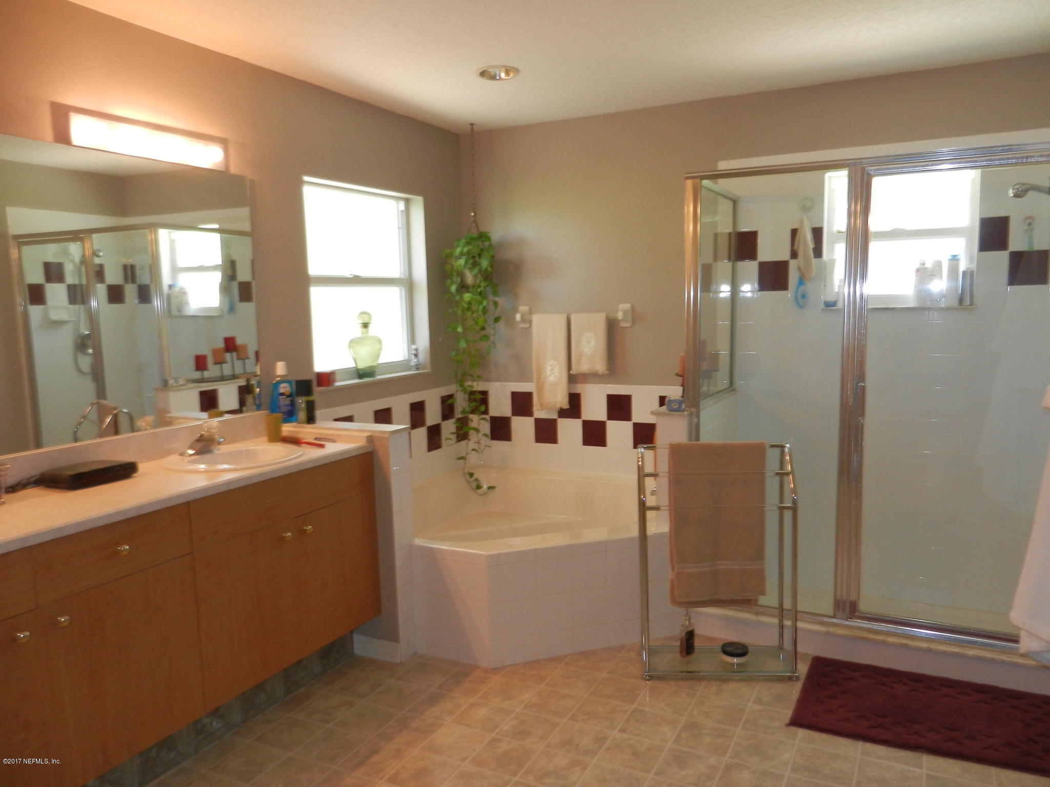 2205 Brownlee Road Seville, FL 32190 - Photo 16 of 27 a large bathroom with a tub a sink and mirror