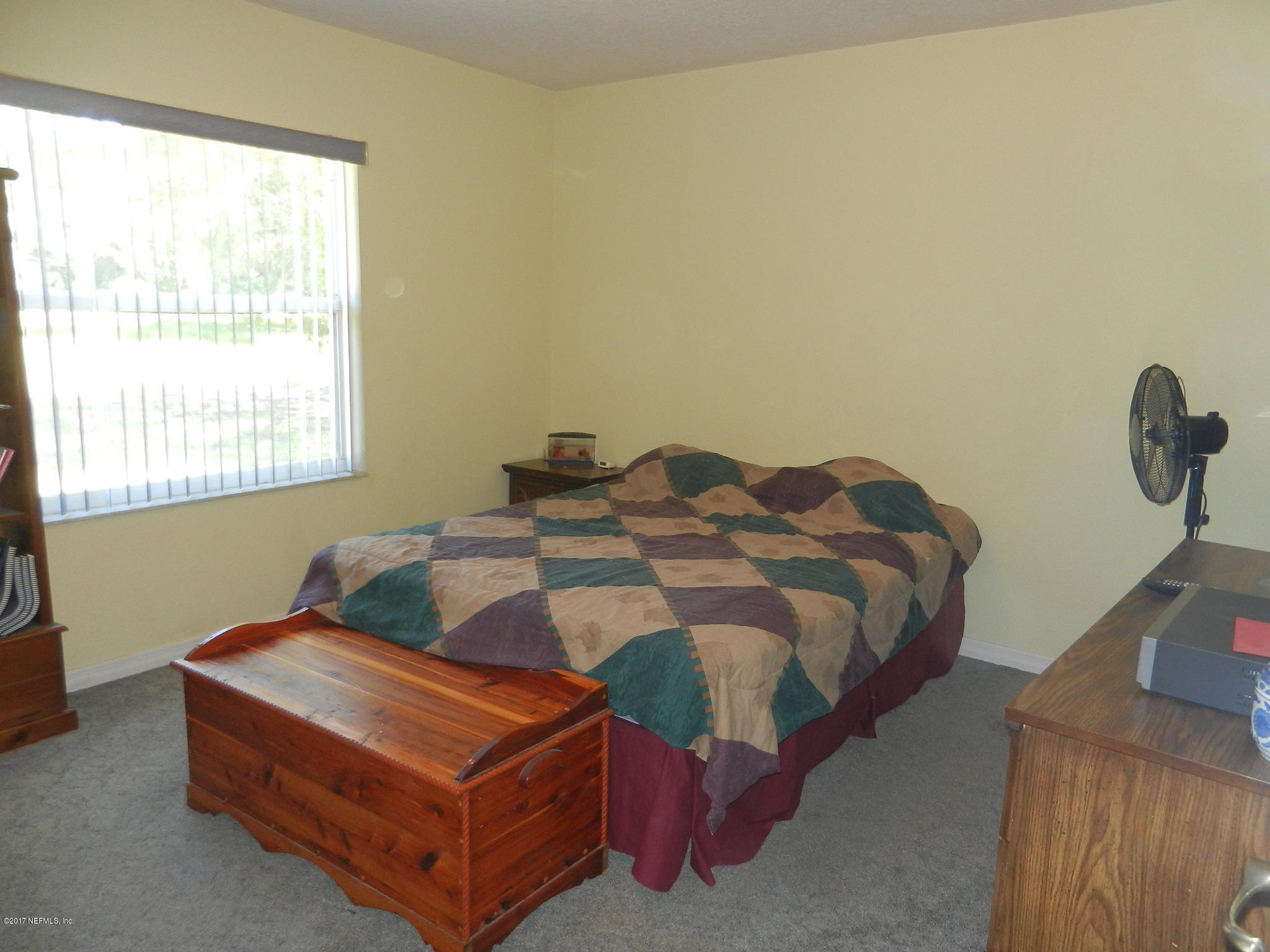 2205 Brownlee Road Seville, FL 32190 - Photo 18 of 27 a bedroom with a bed and window