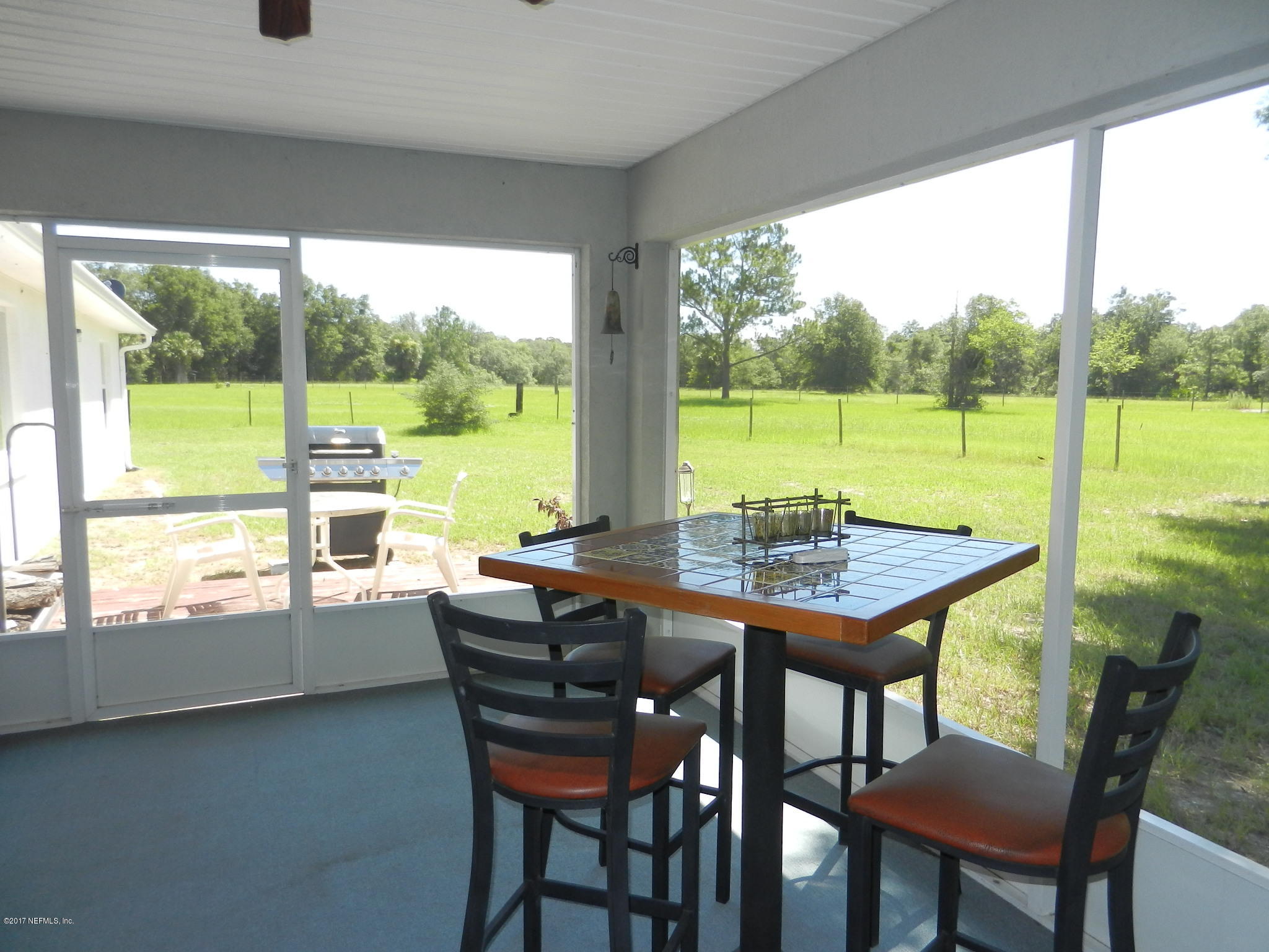2205 Brownlee Road Seville, FL 32190 - Photo 20 of 27 a view of a city from a dining room with a table and chairs