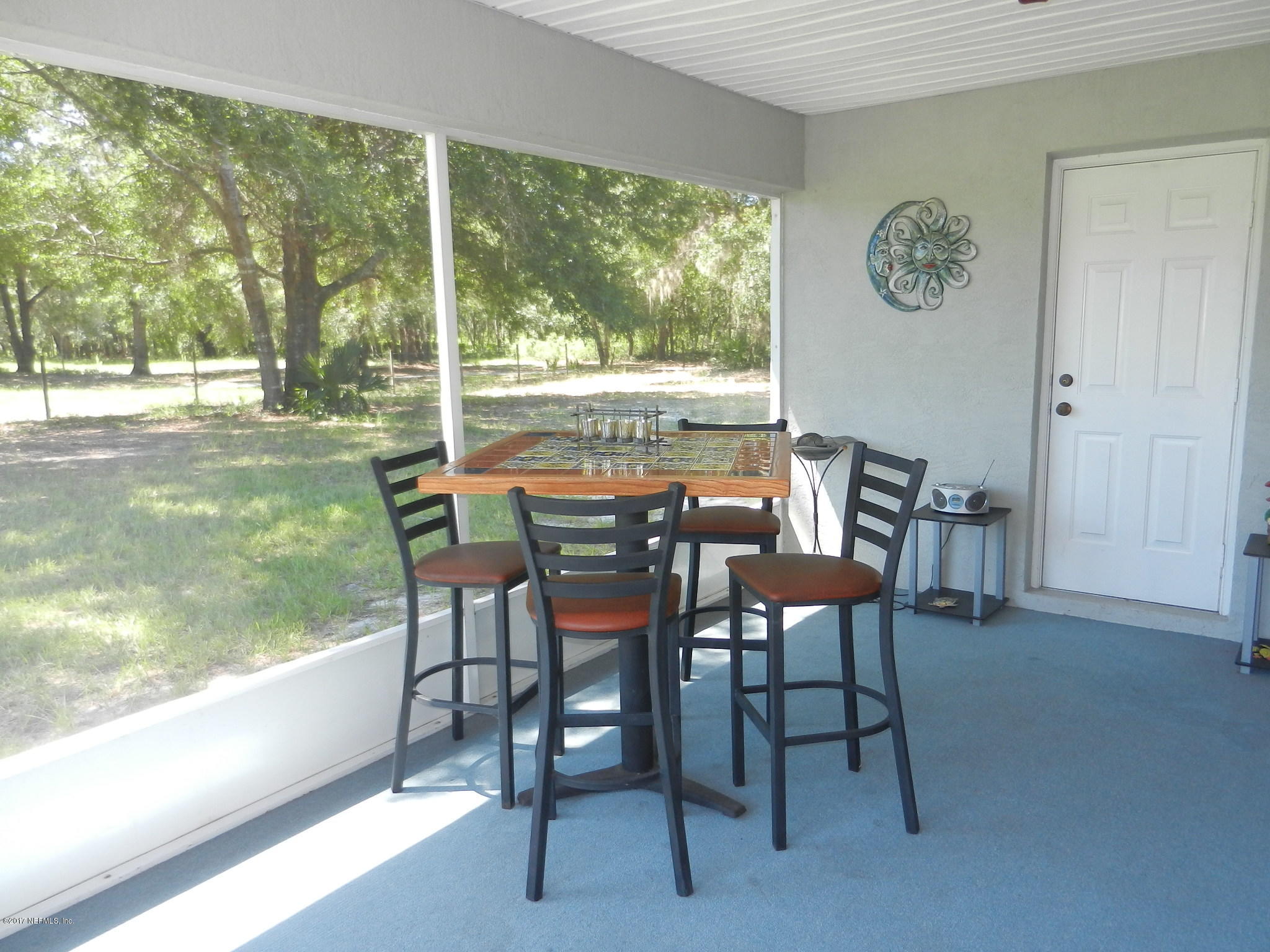 2205 Brownlee Road Seville, FL 32190 - Photo 21 of 27 a view of a dining room with furniture window and outside view