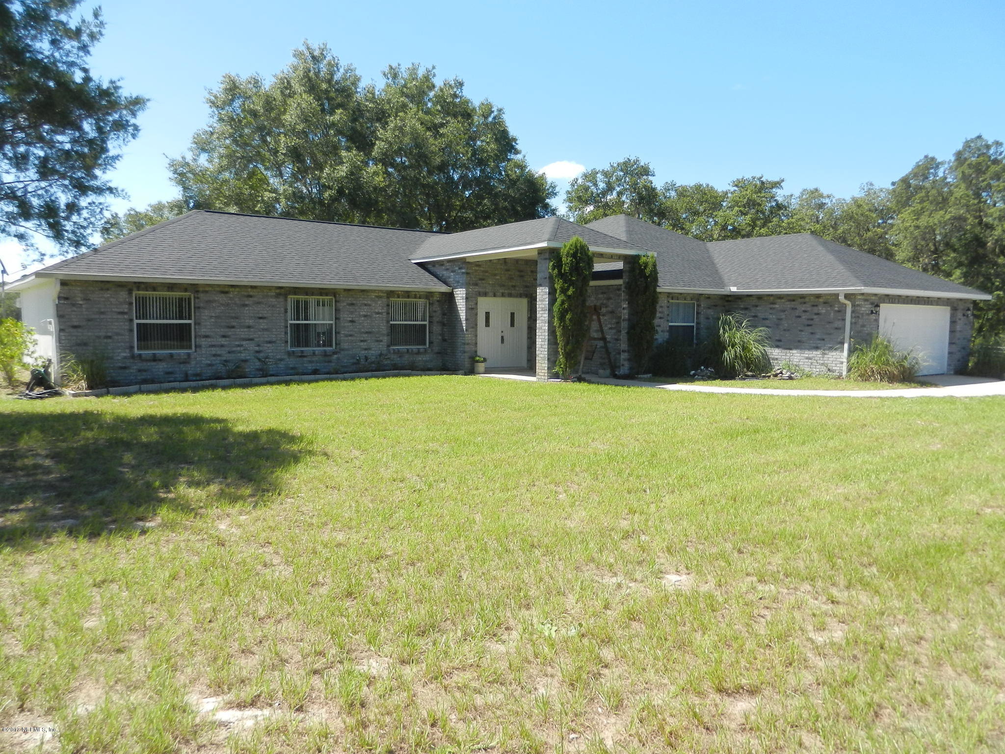 2205 Brownlee Road Seville, FL 32190 - Photo 26 of 27 a view of a house with a yard and garage