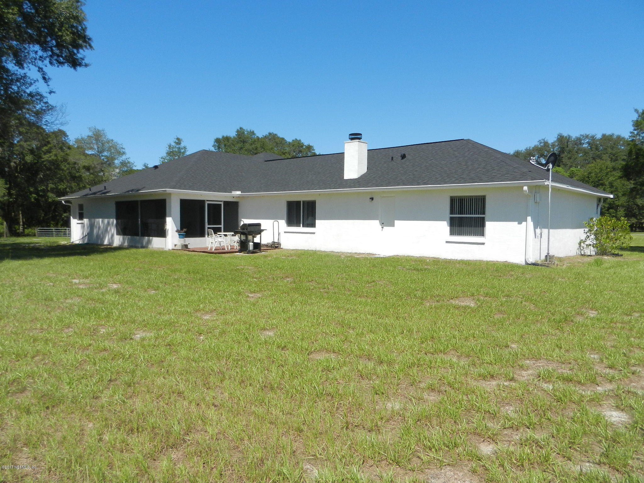 2205 Brownlee Road Seville, FL 32190 - Photo 3 of 27 a front view of a house with a yard and trees