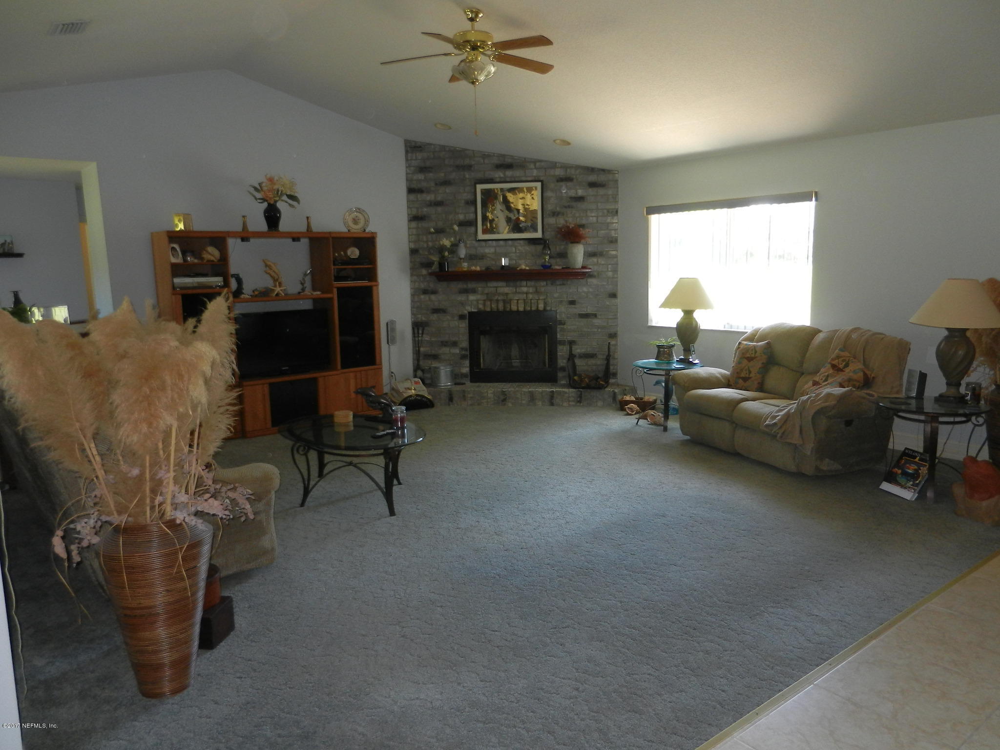 2205 Brownlee Road Seville, FL 32190 - Photo 4 of 27 a living room with furniture and a fireplace