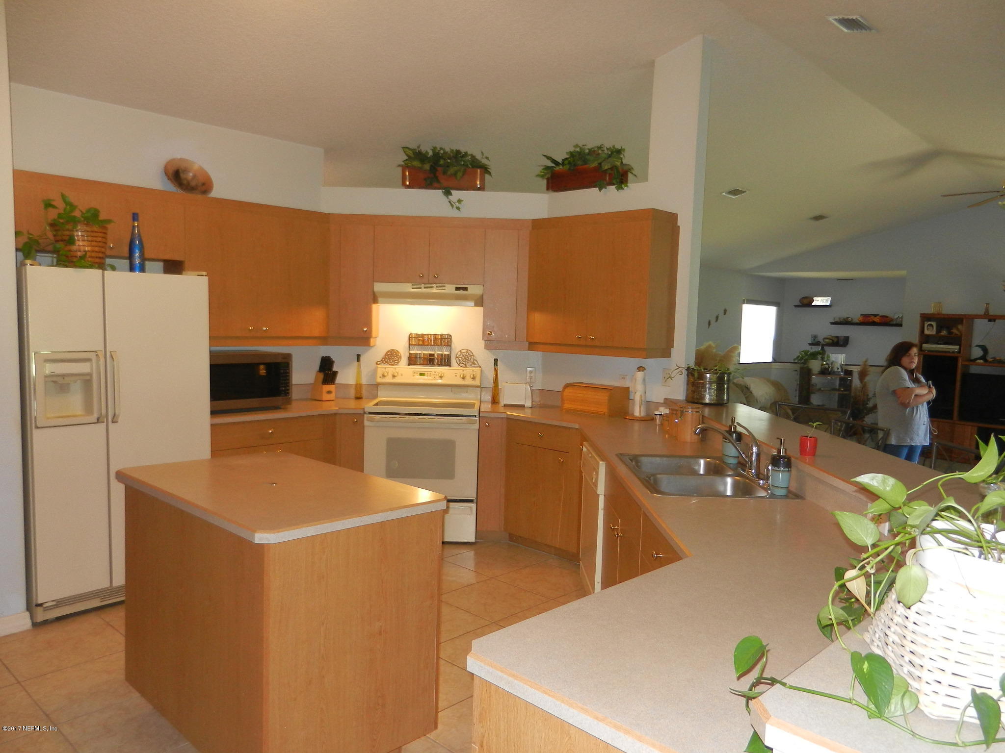 2205 Brownlee Road Seville, FL 32190 - Photo 9 of 27 a kitchen with refrigerator and stove