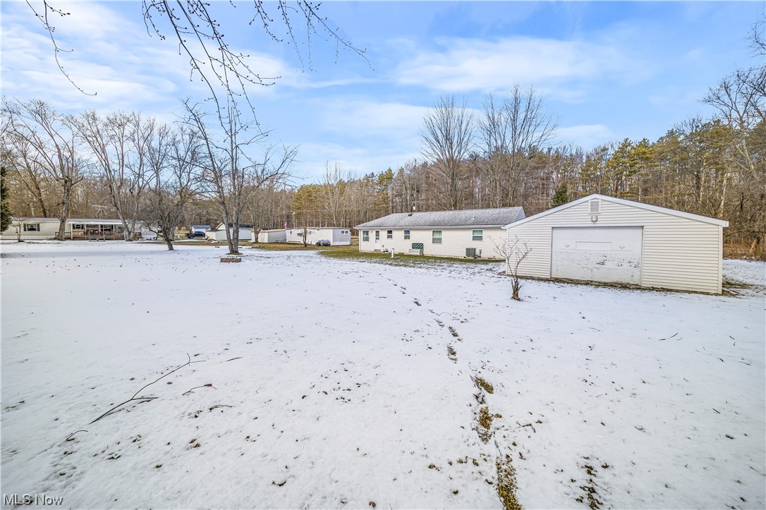 6882 Pymatuning Lake Road Andover, OH 44003 - Photo 7 of 25 Yard covered in snow with a garage
