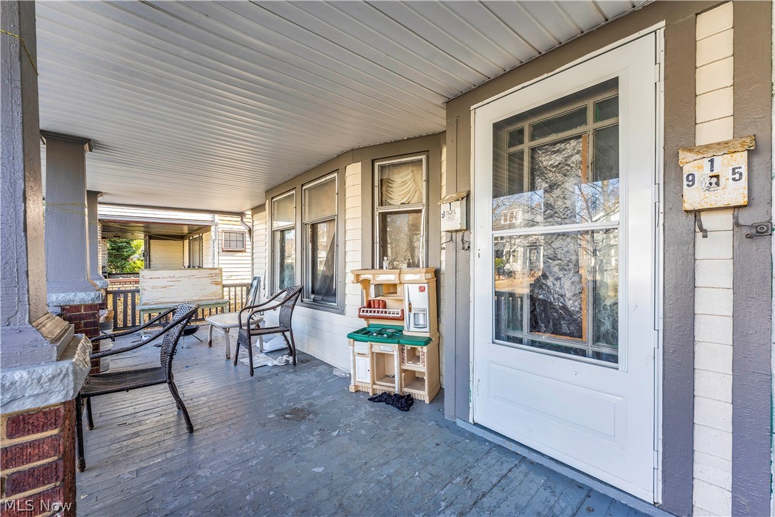 913 Helmsdale Road, Unit 3 Cleveland, OH 44112 - Photo 4 of 19 Wooden porch featuring outdoor dining space