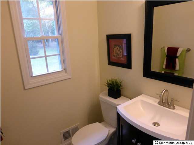 346 Diamond Road Jackson, NJ 08527 - Photo 12 of 23 a bathroom with a toilet a sink and mirror