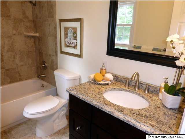 346 Diamond Road Jackson, NJ 08527 - Photo 16 of 23 a bathroom with a granite countertop sink toilet mirror and bathtub