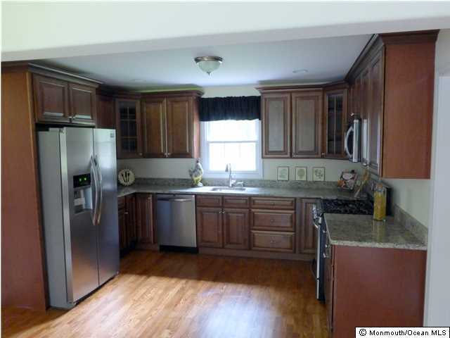 346 Diamond Road Jackson, NJ 08527 - Photo 3 of 23 a kitchen with granite countertop a refrigerator and wooden cabinets