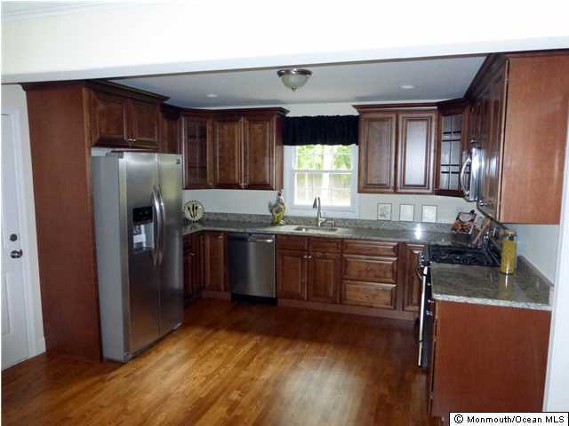 346 Diamond Road Jackson, NJ 08527 - Photo 4 of 23 a kitchen with granite countertop stainless steel appliances and wooden cabinets
