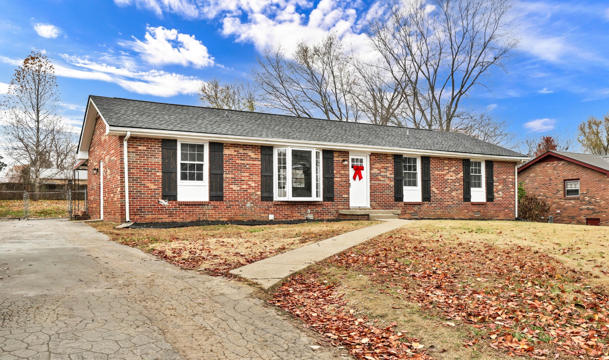 front view of a house with a large trees