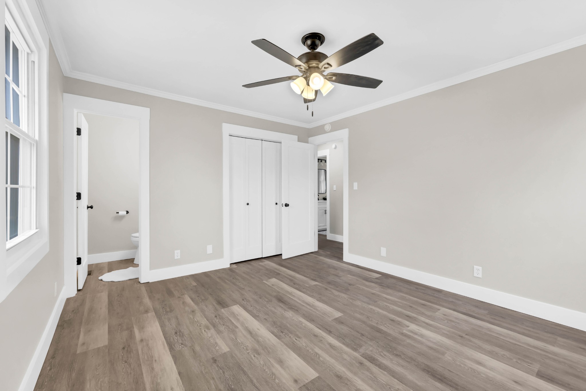 219 Jordan Road Clarksville, TN 37042 - Photo 12 of 22 a view of an empty room with wooden floor and a ceiling fan