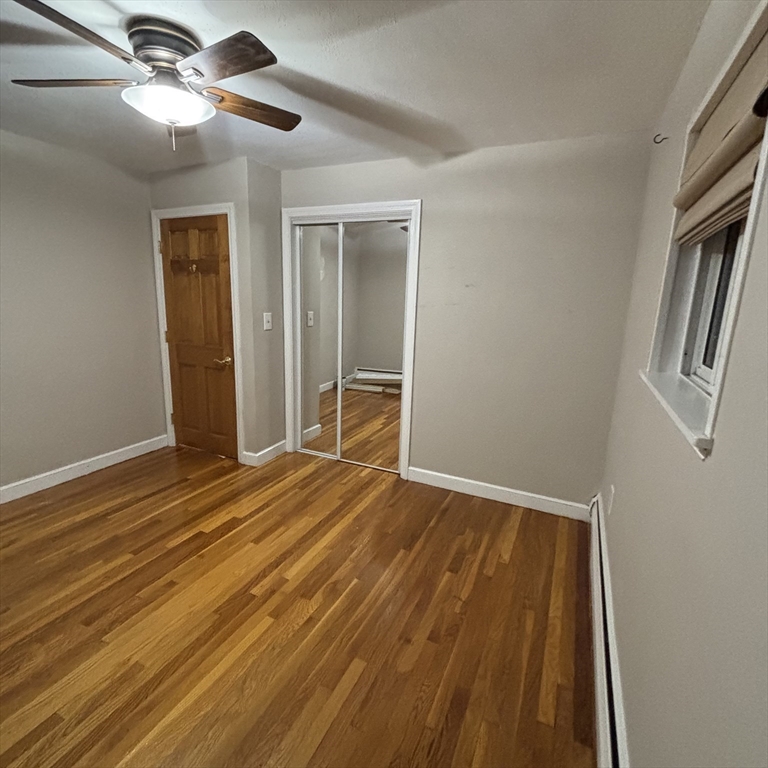 701 Adams Street, Unit 9 Boston, MA 02122 - Photo 11 of 19 a view of empty room with wooden floor