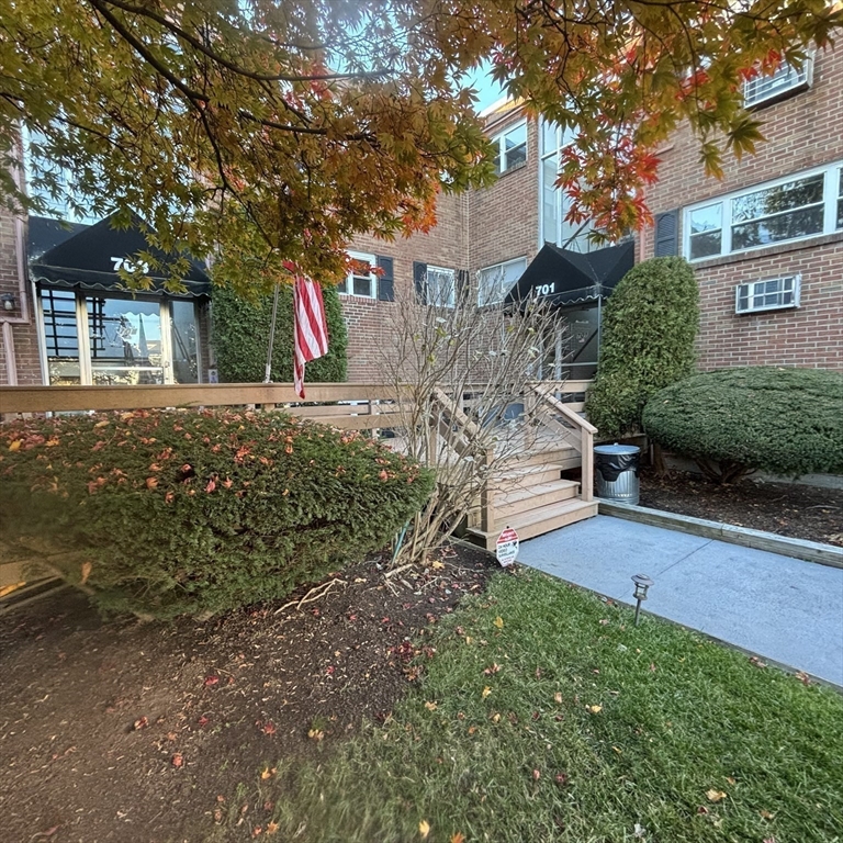 701 Adams Street, Unit 9 Boston, MA 02122 - Photo 16 of 19 a front view of a house with a yard and tree s
