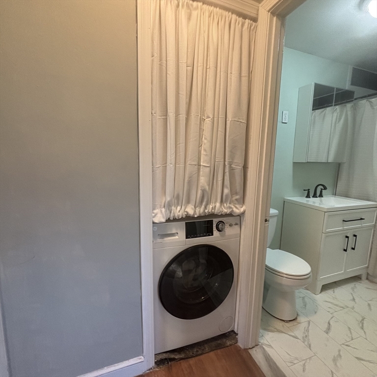 701 Adams Street, Unit 9 Boston, MA 02122 - Photo 8 of 19 a bathroom with a toilet and a sink