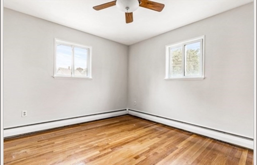 701 Adams Street, Unit 9 Boston, MA 02122 - Photo 9 of 19 a view of empty room with wooden floor