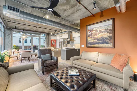 a living room with furniture ceiling fan and a rug