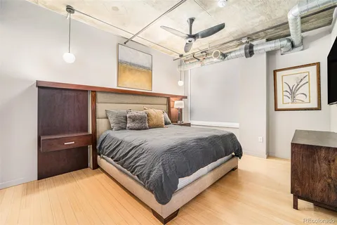 a large bed sitting in a bedroom next to a bathroom