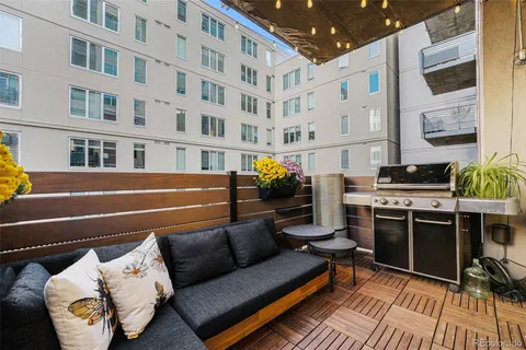 a balcony with furniture and a potted plant