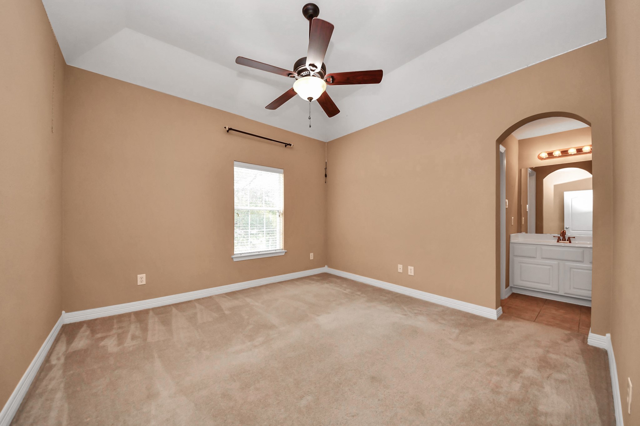 17618 Raven Canyon Lane Houston, TX 77095 - Photo 29 of 45 Comfortable bedroom with high ceilings and a cozy ambiance, ideal for relaxation.