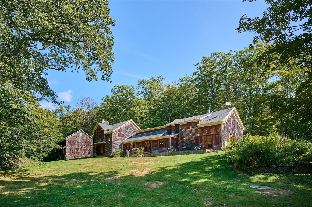 a front view of house with yard and green space
