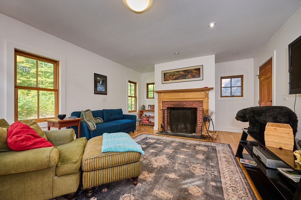 81 Smith Road Ashfield, MA 01330 - Photo 14 of 41 a living room with furniture and a fireplace