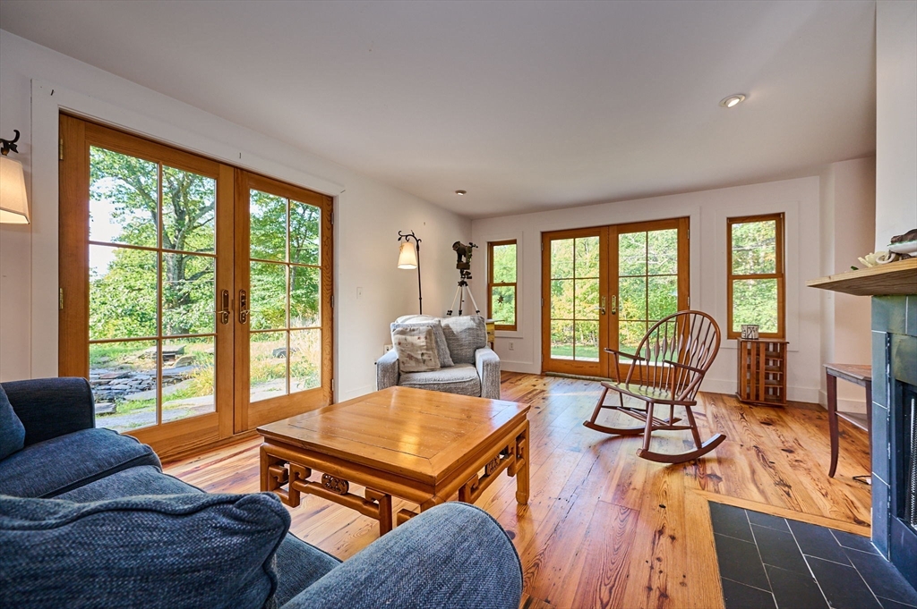 81 Smith Road Ashfield, MA 01330 - Photo 17 of 41 a living room with furniture and floor to ceiling windows