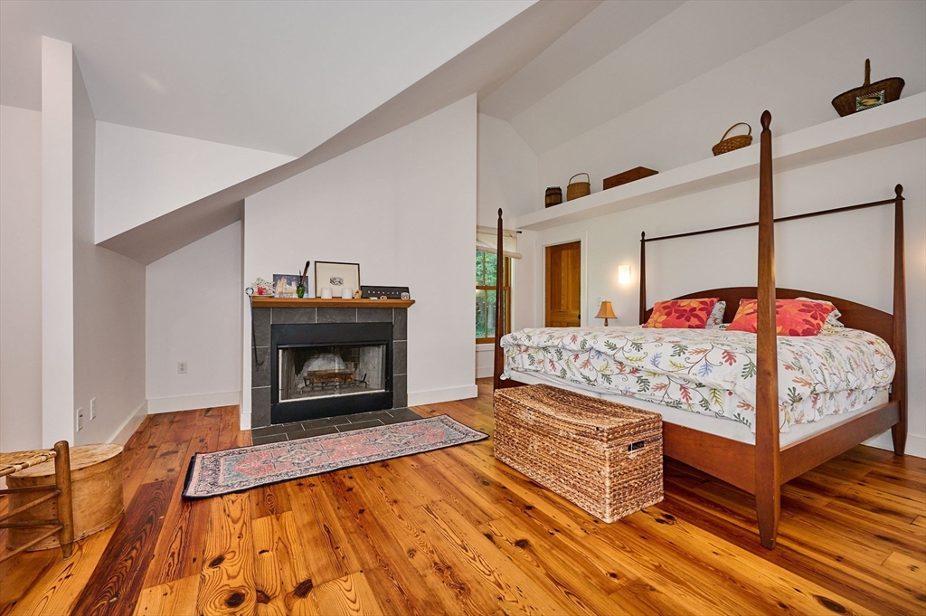 81 Smith Road Ashfield, MA 01330 - Photo 21 of 41 a bedroom with a bed and a fireplace