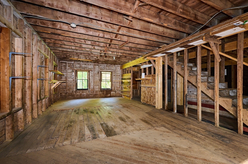 81 Smith Road Ashfield, MA 01330 - Photo 40 of 41 a view of an empty room with wooden floor and windows